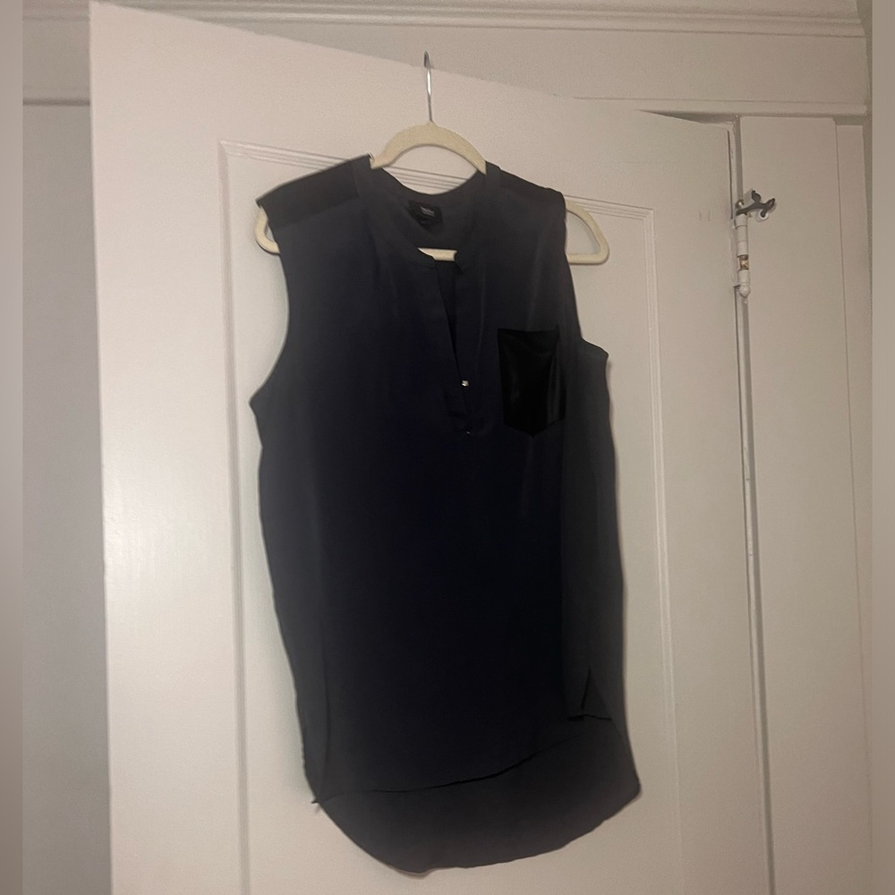 Beautiful blouse with faux leather like detailed pocket.